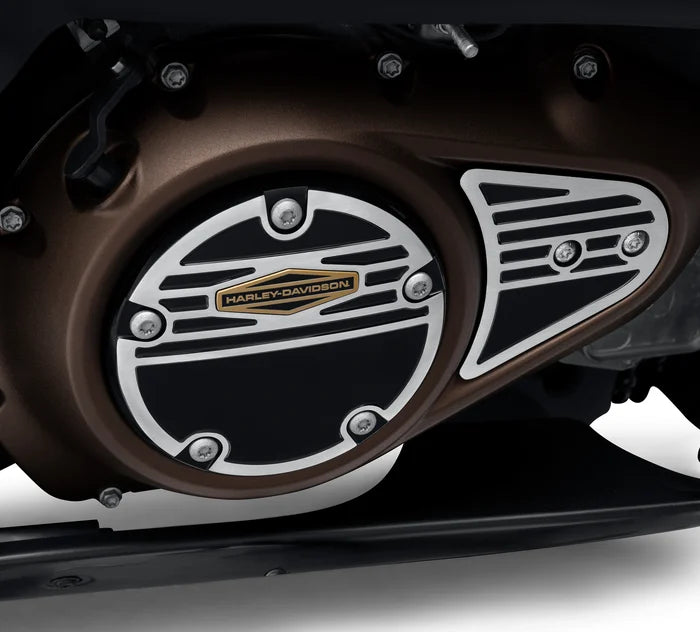 Silver circle clutch medallion cover with black detailed and gold Harley-Davidson logo